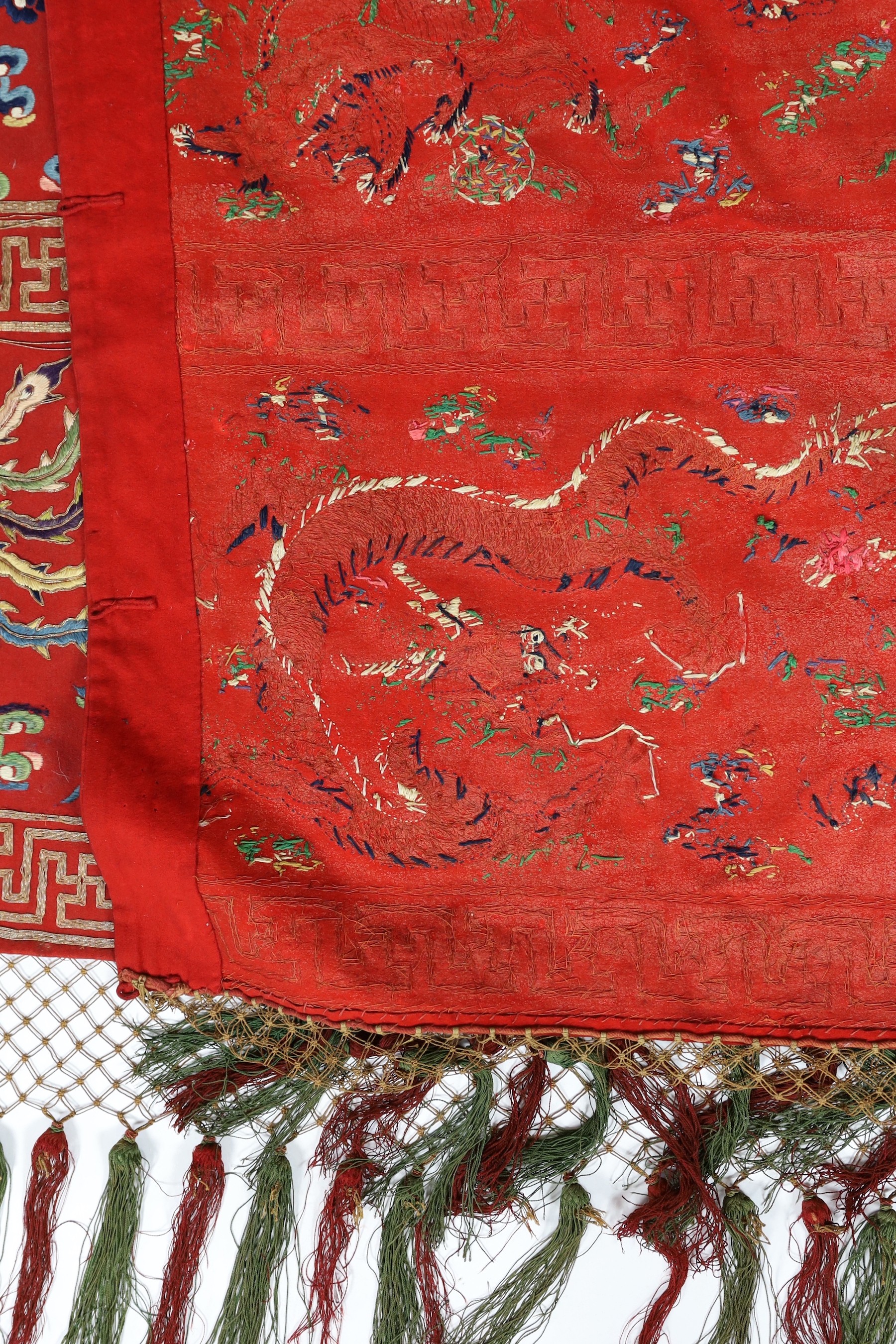 A Chinese embroidered silk ‘dragon, phoenix and lion’ panel or table frontal, late Qing dynasty, 117cm x 337cm